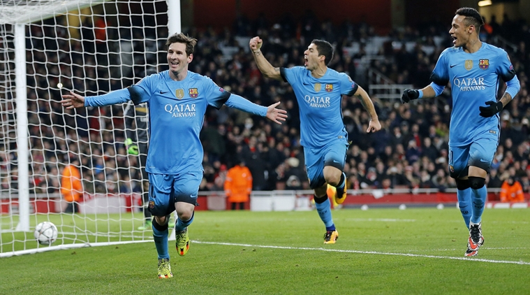 Barcelona players Neymar, right, and Luis Suarez celebrate after Lionel Messi, left, scored the second goal during the soccer Champions League round of 16 first leg soccer match between Arsenal and Barcelona at the Emirates stadium in London, Tuesday, Feb. 23, 2016. (AP Photo/Frank Augstein)
